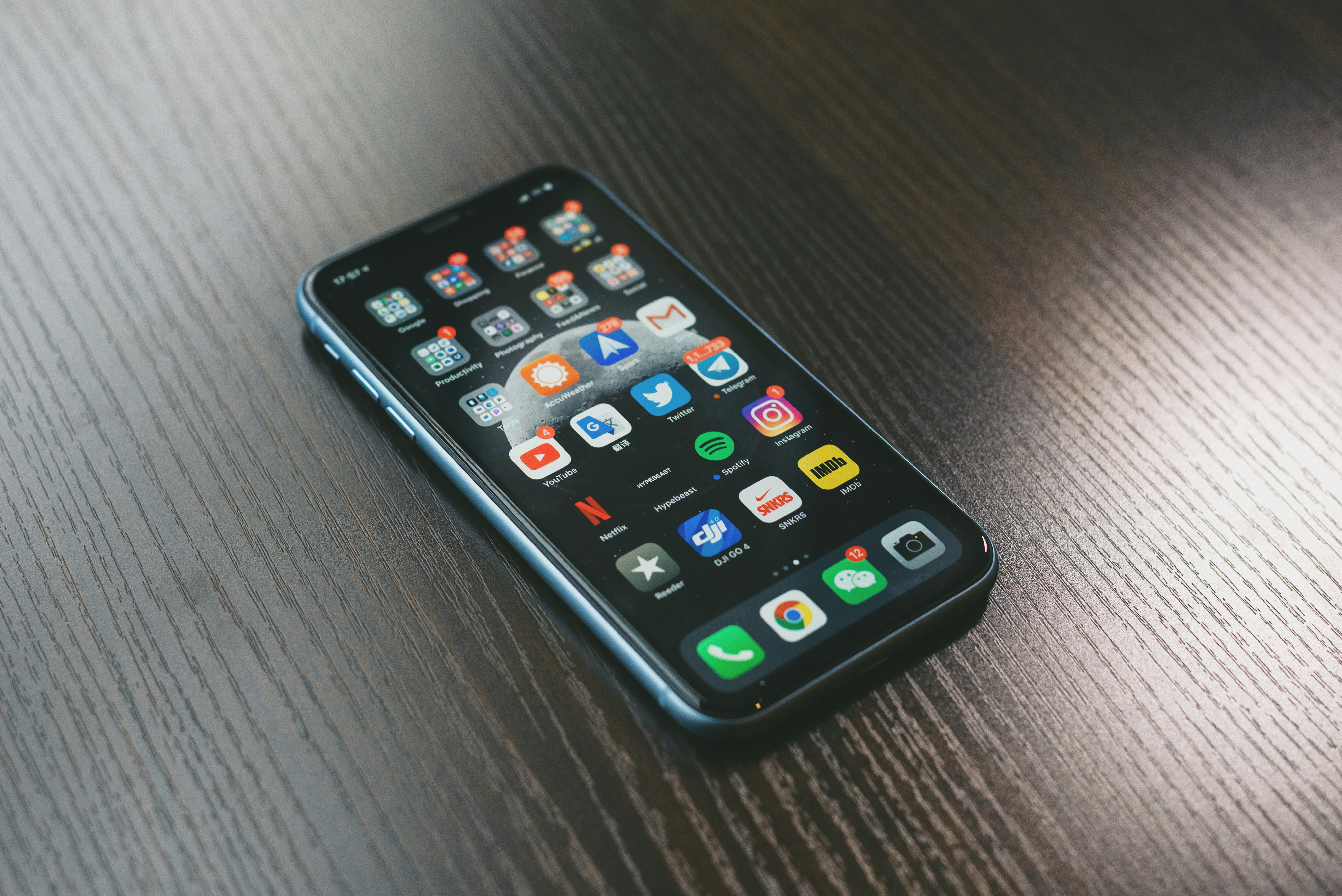 A smartphone home screen with WeChat, Alipay, DiDi, and Amap — the four essential apps for any traveler to China in 2026.