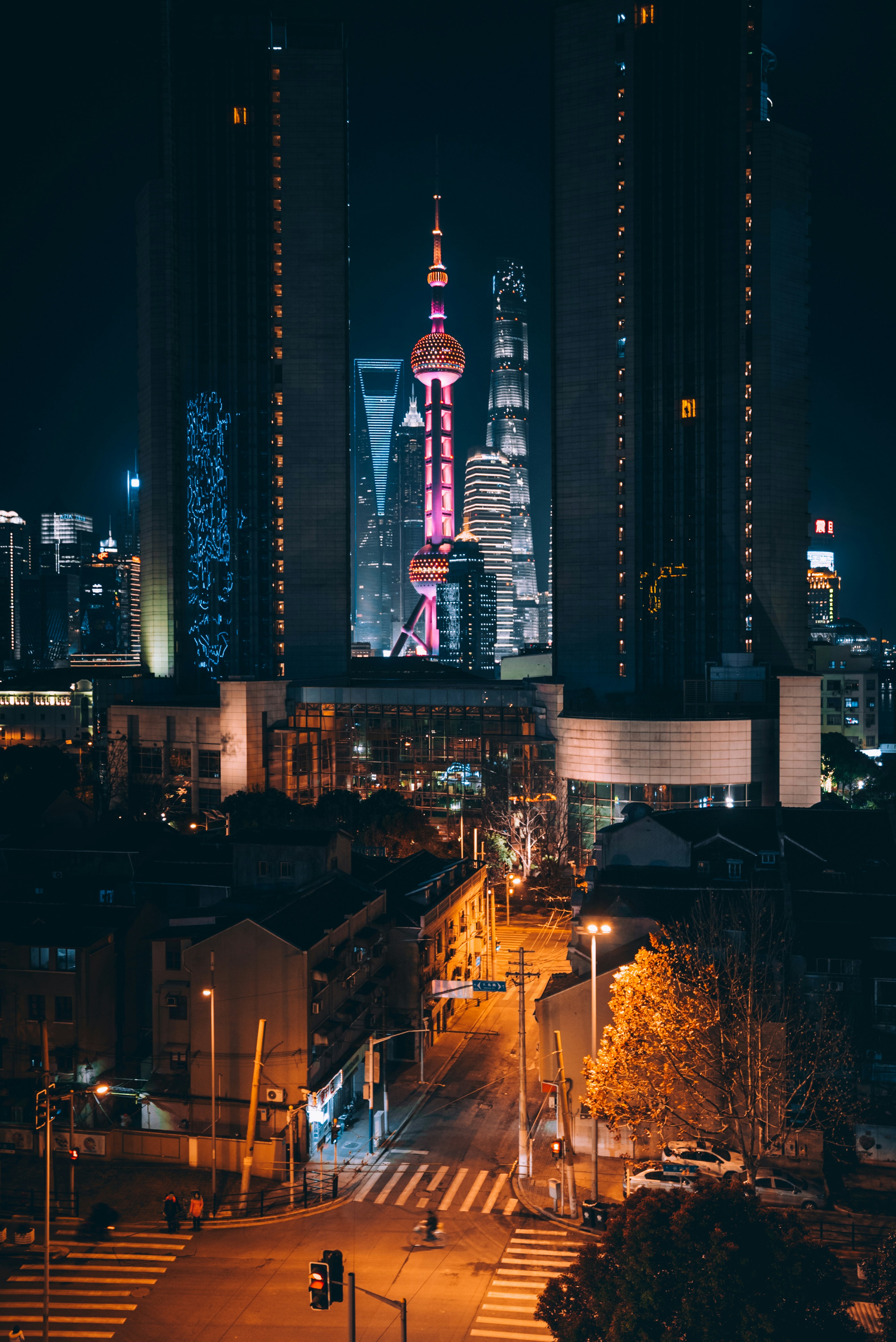 An evening street scene in Shanghai with pedestrians and neon signs — China is one of the safest large countries in the world for foreign tourists in terms of physical safety.
