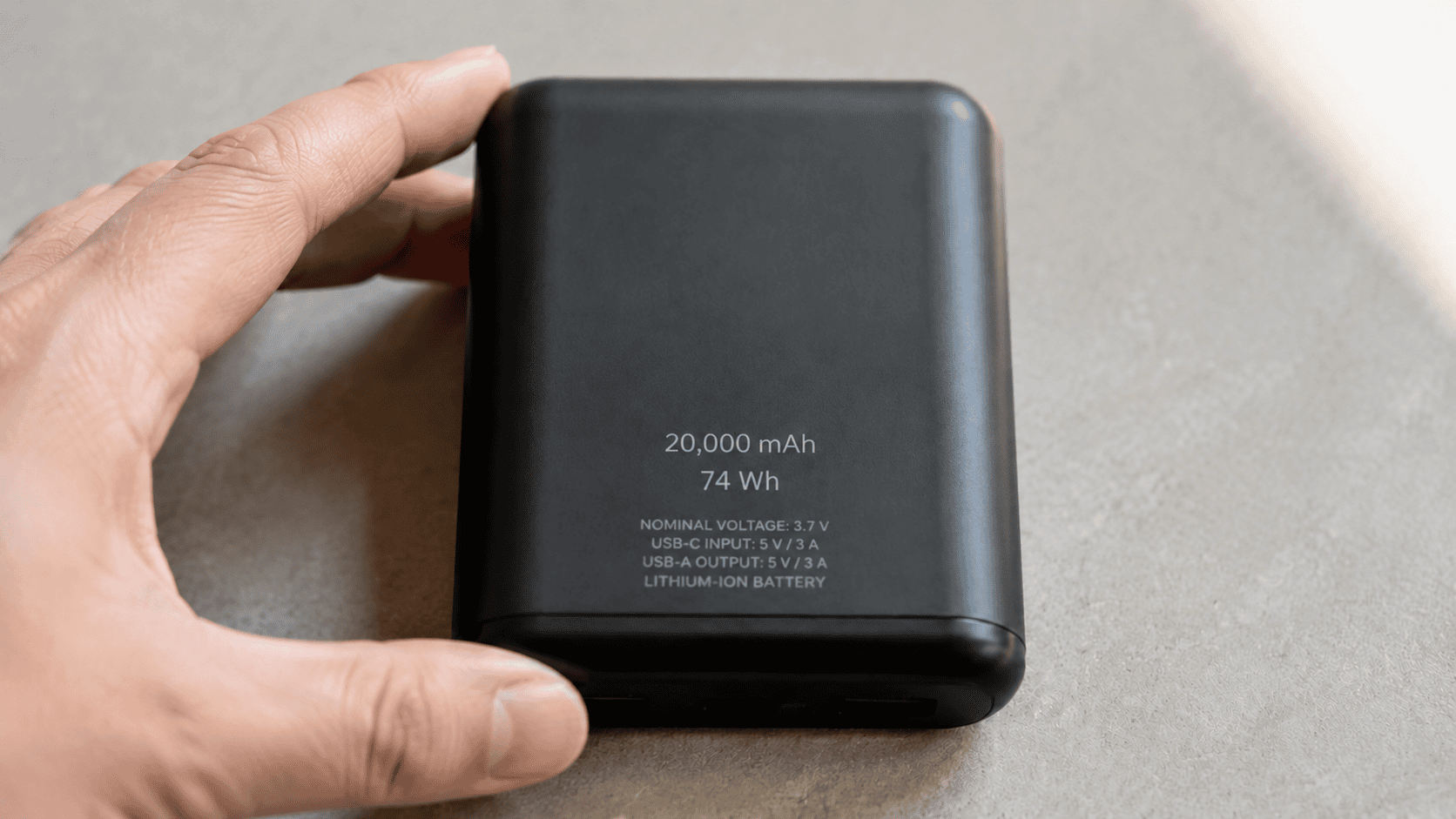 Power bank label showing 20,000 mAh, 3.7 V, and 74 Wh