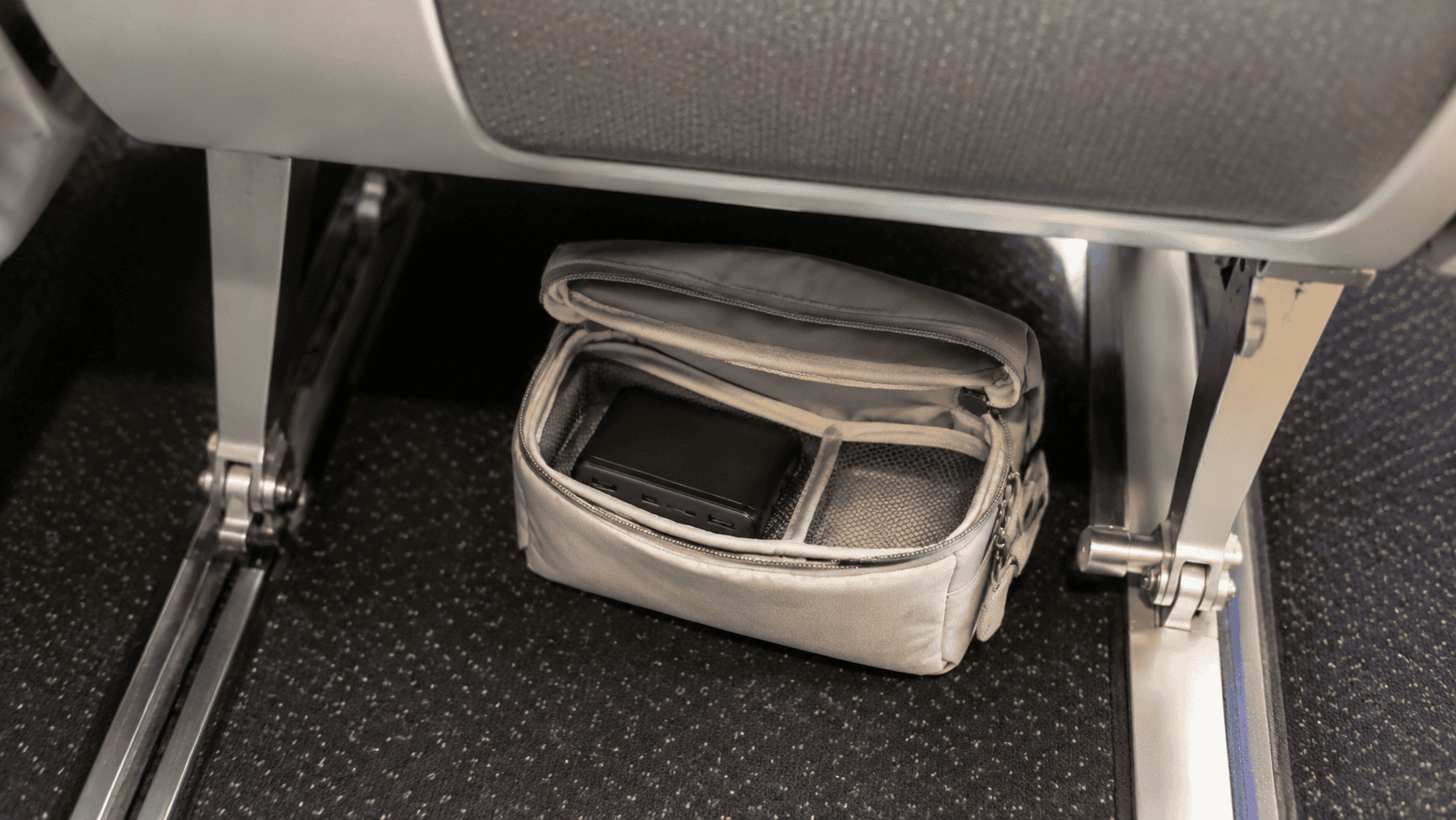 Power bank stored inside an accessible under-seat carry-on bag