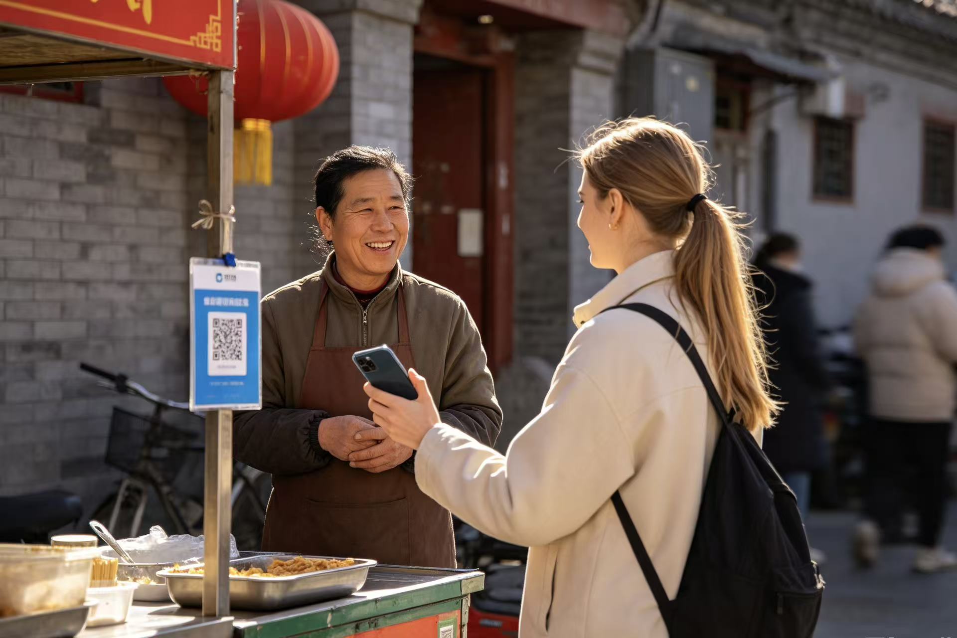 Foreign tourist scanning Alipay QR code at Beijing hutong food stall