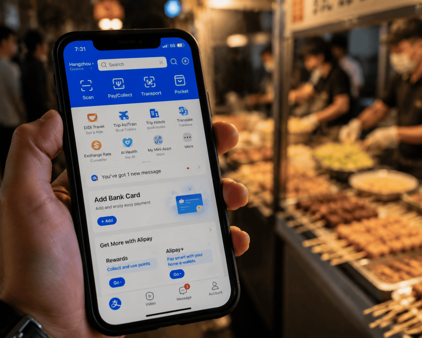 Smartphone showing Alipay app with street food stall in background